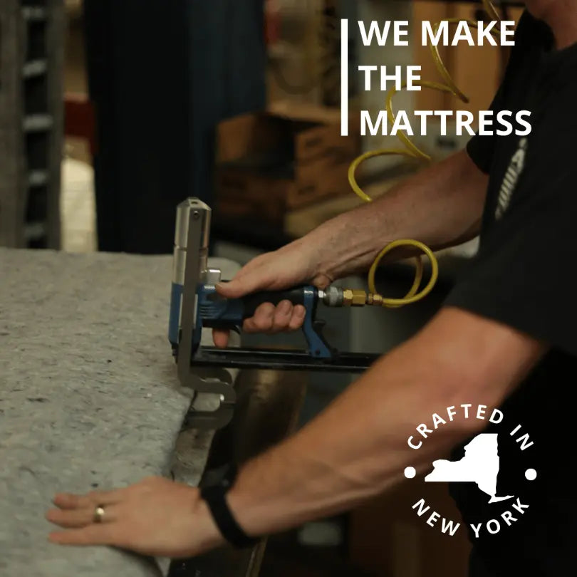 Crafted in New York: Worker attaching insulator pad to mattress spring with hog ring gun.