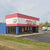 amestown Mattress store in Rochester, situated on W Henrietta Road. The storefront has large windows displaying mattresses and a clear Jamestown Mattress sign. The building is free standing building painted red, white, and blue