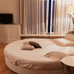 Minimalist bedroom with a custom round mattress, demonstrating design flexibility.
