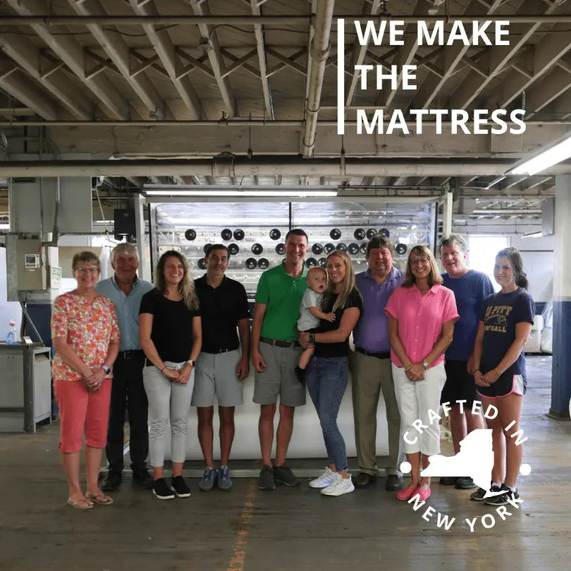 The Pullan family inside the factory, showcasing their involvement in front of a mattress quilting machine.