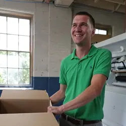 Aaron Pullan at work in the mattress factory, focused on quality production.