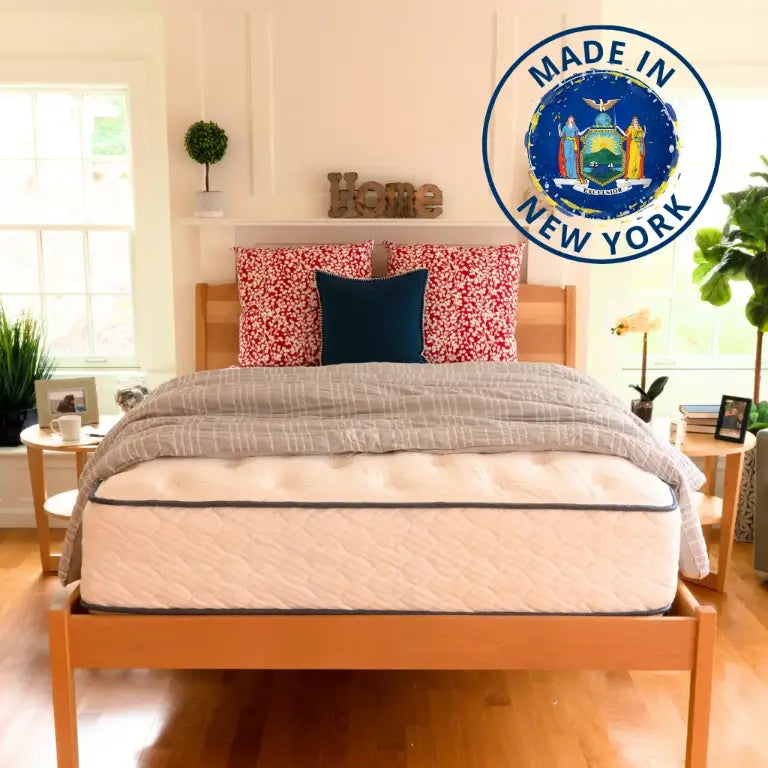Mattress Store in Buffalo, NY: Bed on wood platform with NY flag logo, 'Made in New York'.